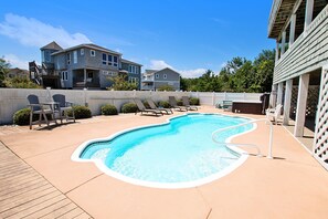A swimming pool with lounge chairs and a wooden deck. - Oceanside-Priv Pool, Htub, Resort Access -133, I SEA the Light (Corolla)