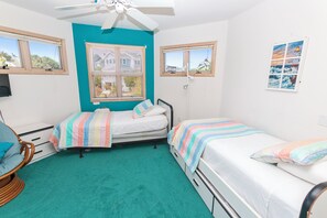 A bedroom with two beds, a ceiling fan, and a window with blinds. - Oceanside-Priv Pool, Htub, Resort Access -133, I SEA the Light (Corolla)
