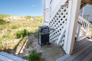A deck area with a grill and a wooden fence. - OCEANFRONT, Ocean views, Dogs Welcome, Hot Tub- CP24, ROAR by the Shore (Corolla)
