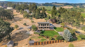 A modern two-story house with a large deck and a well-maintained lawn. - Summers Hill - Newly Built Wine Country Estate (Carlton)
