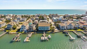 A coastal residential area with houses, a marina, and a view of the ocean. - Waterfront Slice of WB Paradise w Dock and Boat Lift! PRIME location! (Wrightsville Beach)