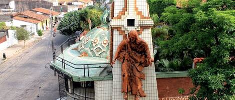 A building with a tiled facade and a statue of a figure.