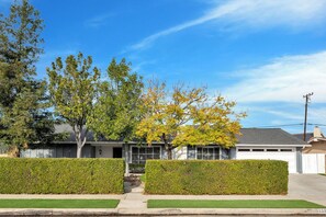 A residential house with a front yard, a driveway, and a garage.