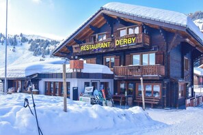 A wooden mountain restaurant with a sign reading 'RESTAURANT DERBY' and a ski lift visible in the foreground. - Your Perfect Mountain Stay, Wallis 1064 (Wallis)
