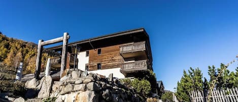 A two-story building with a wooden facade and balconies.