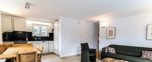 A compact living space with a kitchenette, dining area, and seating area. - Alpine Comfort & Style, Wallis 1053 (Wallis)