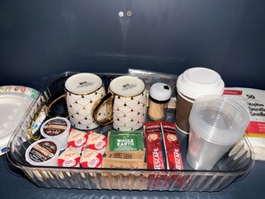 A tray with various items including coffee mugs, coffee cups, and coffee pods. - Stylish Basement Suite| Queen Bed|5 minutes to Airport (Dieppe)