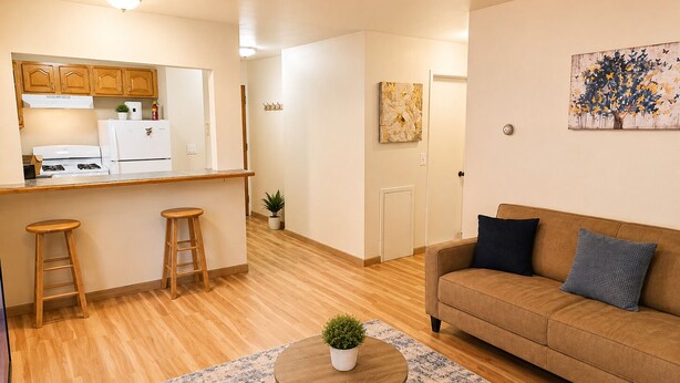 A modern living space with a kitchen, a dining area, and a seating area.