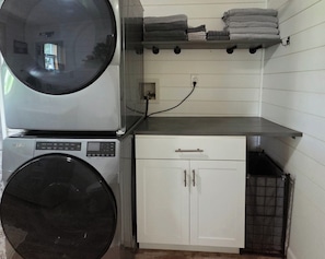 A laundry area with a washing machine, dryer, and a cabinet.