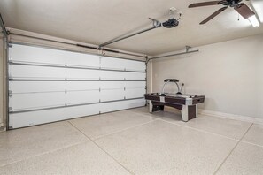 A garage with a closed white garage door, a ceiling fan, and a pool table. - PV 8: Private Spa, BBQ, Air Hockey & Resort Amenities (Santa Clara)