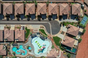 A residential area with multiple houses, a swimming pool, and a tennis court. - PV 8: Private Spa, BBQ, Air Hockey & Resort Amenities (Santa Clara)