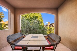 A balcony with a table and chairs, a view of trees and houses, and a clear sky. - Coral Ridge 1998, Game Console, Resort Pool, Golf Nearby, and Golf Nearby! (St. George)