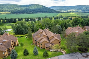 A residential area with multiple two-story houses featuring sloped roofs and wooden exteriors.