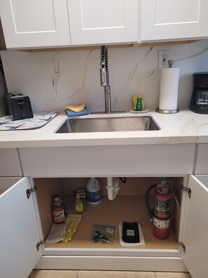 A kitchen with a stainless steel sink, a coffee maker, and a paper towel holder. - Free Parking Ocean Studio Full Kitchen (Hollywood)