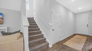 A modern interior with a staircase, a door, and a rug. - Enjoyable 4-bedroom house with AC in charming Little River (Little River)