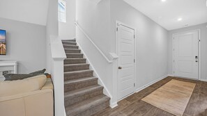 A modern interior with a staircase, a door, and a rug. - Enjoyable 4-bedroom house with AC in charming Little River (Little River)