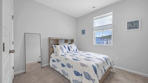 A bedroom with a bed, a window, and a door. - Enjoyable 4-bedroom house with AC in charming Little River (Little River)