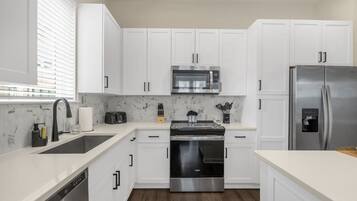 Coffee/tea maker, fridge, microwave, oven