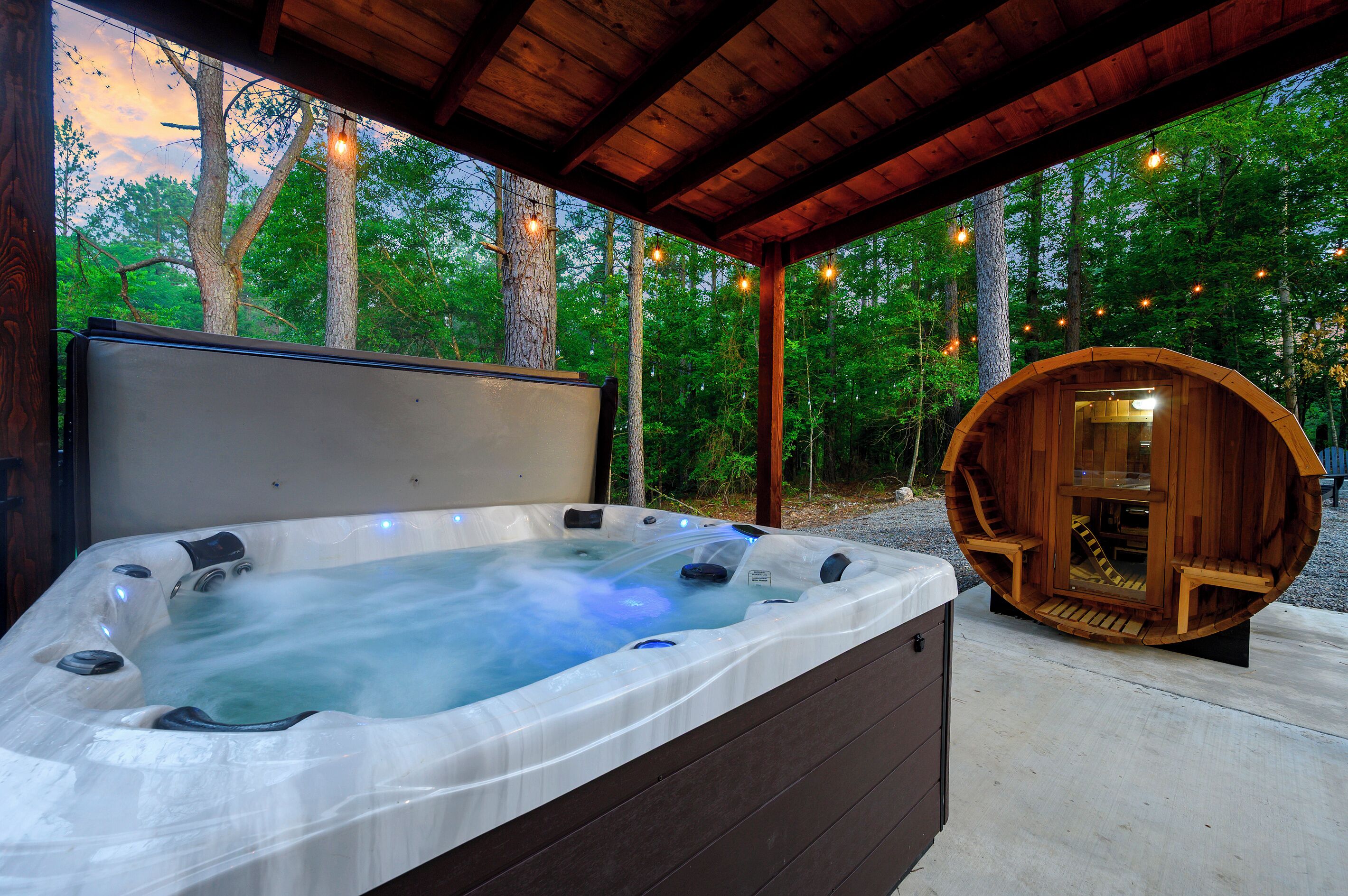 A hot tub with a wooden deck and a wooden structure with a bench.