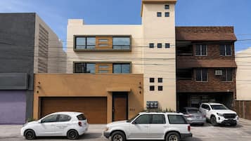 A modern building with a garage, a two-story structure, and a brick facade.