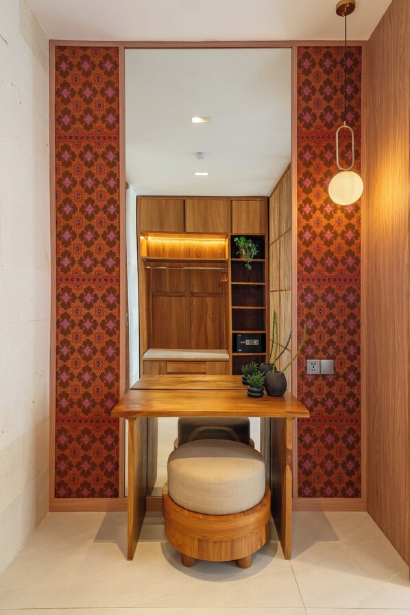 A compact room with a wooden table, bench, and built-in shelving.
