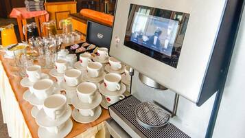 A coffee machine with a digital display, a coffee grinder, and a tray of white cups and saucers.