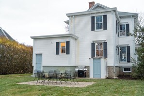 A two-story house with a front porch, a grill, and a seating area. - Downtown Mystic Getaway - Porch, Yard & Bunk Room (Mystic)