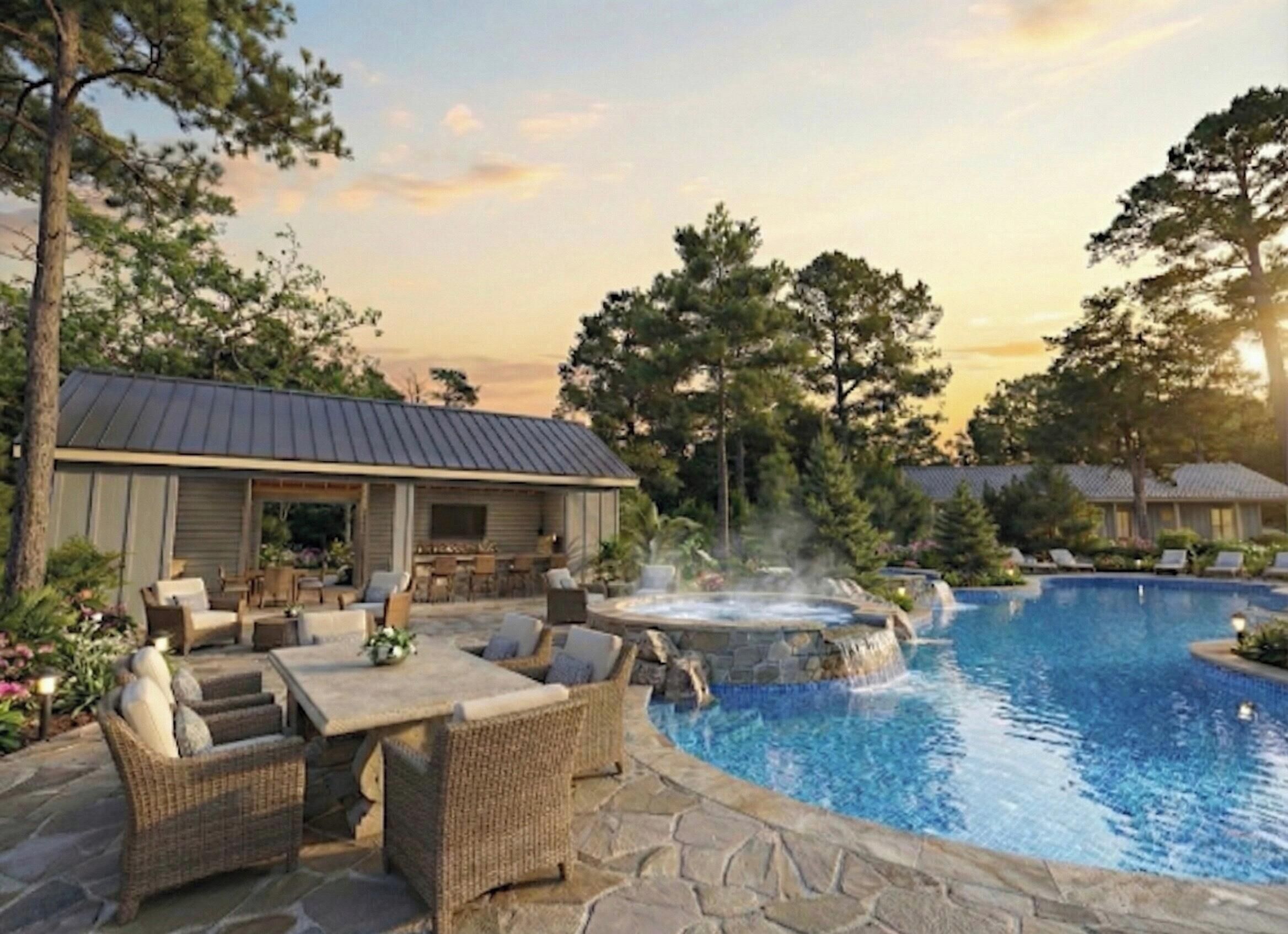 A pool area with a hot tub, outdoor furniture, and a building with a metal roof.