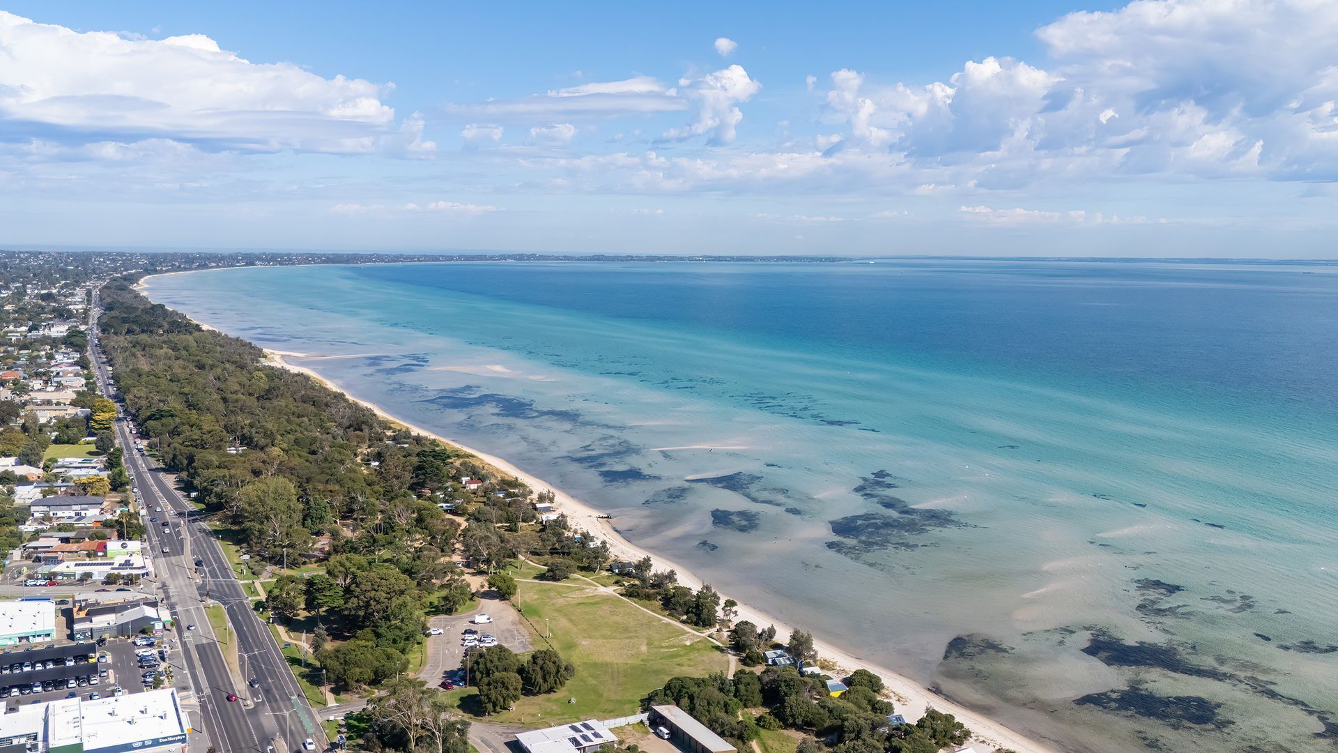 A coastal road with a beach and ocean.