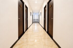 A hotel hallway with doors numbered 205 and 206, leading to a balcony.