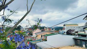 A residential area with houses, a church, and a hill in the background.