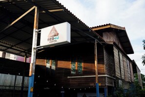 A wooden building with a sign for Bed4U Hostel.