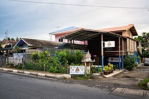 A two-story building with a covered porch and a sign for Bed & Breakfast.