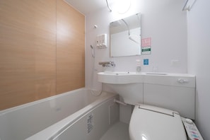 A bathroom with a bathtub, a sink, and a toilet. - R B Hotel Sendai East (Sendai)