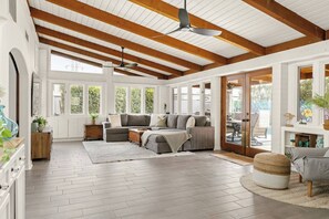 A spacious living room with a wooden ceiling, large windows, and a cozy seating area. - Palmera Haus: Scottsdale Home, Pool & King Suites (Scottsdale)