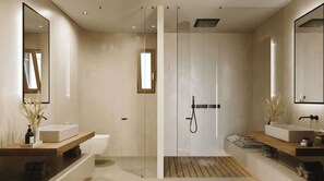 A modern bathroom with a glass-enclosed shower, two sinks, and a large mirror. - Magma Resort Santorini in of the Unbound Collection by Hyatt (Santorini)