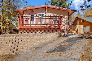 A two-story building with a red exterior and a balcony. - Ski View Chalet #2215 (Big Bear Lake)