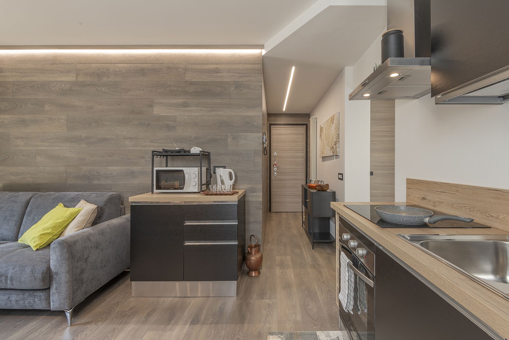A modern kitchen with a built-in oven, microwave, and stove.