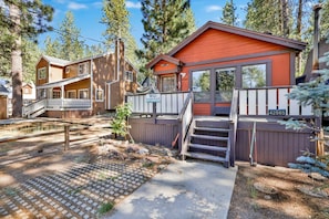A cabin with a wooden exterior, a porch, and a deck. - Bearadise Cottage #2275 (Big Bear Lake)