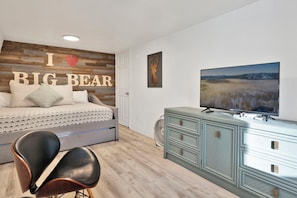 A bedroom with a bed, a dresser, a TV, and a chair. - Fox & Bears Retreat#2190 (Big Bear Lake)