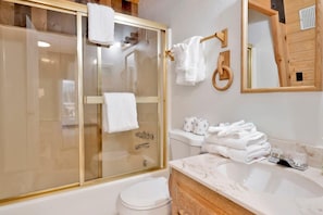 A bathroom with a glass-enclosed shower, a toilet, and a sink with a marble countertop. - Fox & Bears Retreat#2190 (Big Bear Lake)