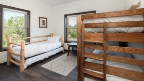 A room with a bunk bed, a single bed, a desk, and two windows. - Mountain Retreat at the Base of Granby Ranch (Granby)