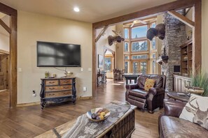 A spacious living room with a fireplace, a television, and a pool table. - Buffalo Teal Lodge|Hot Tub|Resort Amenities (Klamath Falls)