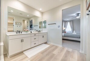 A modern bathroom with a large mirror, two sinks, and a walk-in shower. - @marbella Lane -amazing 5br Home In Rancho Mission (San Juan Capistrano)