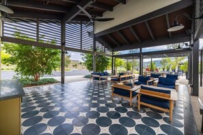 An outdoor seating area with a patterned floor, wooden furniture, and a view of the surrounding landscape. - @marbella Lane -amazing 5br Home In Rancho Mission (San Juan Capistrano)