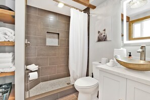 A modern bathroom with a shower, toilet, and sink. - Big Bear Gambrel #2066 (Big Bear Lake)