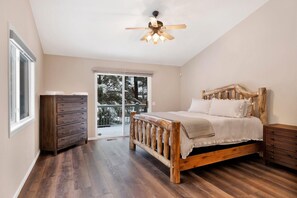 A bedroom with a wooden bed, a dresser, and a ceiling fan. - Castle Glen Gem #2220 (Big Bear Lake)