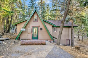 A cabin with a green roof, a door, and a mailbox. - Whispering Woods #2375 (Big Bear Lake)
