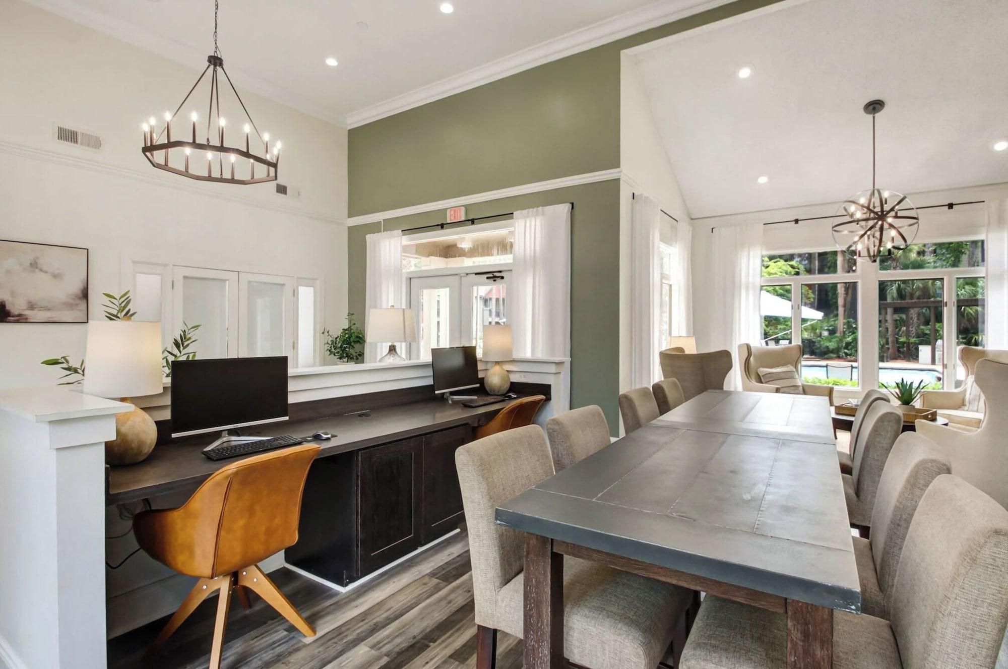 A modern kitchen with a dining area, a large window, and a view of the outdoors.