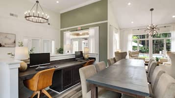 A modern kitchen with a dining area, a large window, and a view of the outdoors.